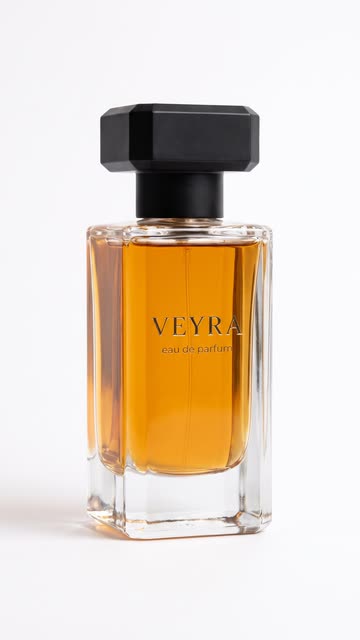 Amber perfume bottle on a plain white background